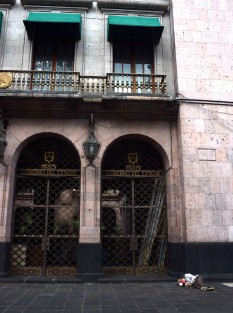 Una persona en situación de calle duerme a las puertas del Palacio de Gobierno, tal vez en espera de que el DIF lo ayude. 
