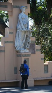 Un hombre de aspecto humilde aprecia una de las virtudes de la ciudad de Xalapa,  en este caso la que representa la justicia, eso sí, con su cubreboca bien puesto.